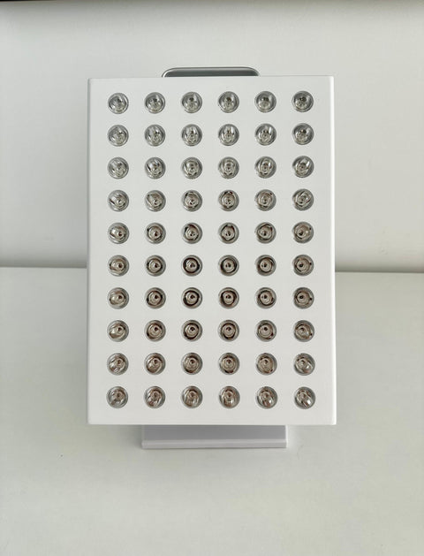 Close-up of white red light therapy panel with multiple LED bulbs, showing detailed specifications and dimensions for cellular healing